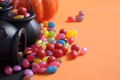 Toy cauldrons filled with candy.