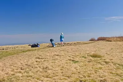 A hiker at the top of Gregory Bald.