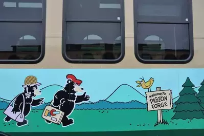 A closeup of the cartoon bears on the side of a Pigeon Forge trolley.