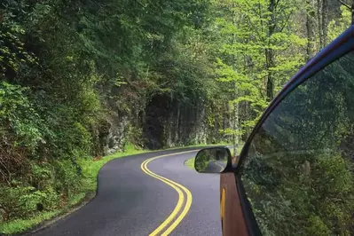 Car driving on a road through the Smoky Mountains