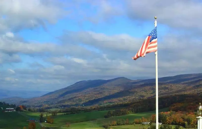American flag with the Smoky Mountains in the background