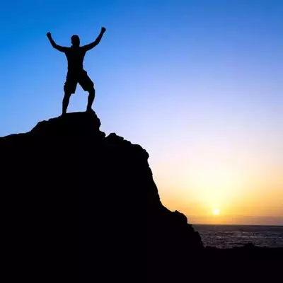 man on top of a mountain