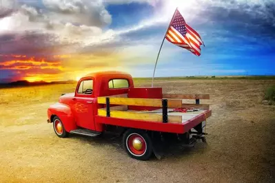 Red pickup truck with American flag