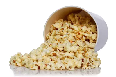 Popcorn spilling out of white bucket
