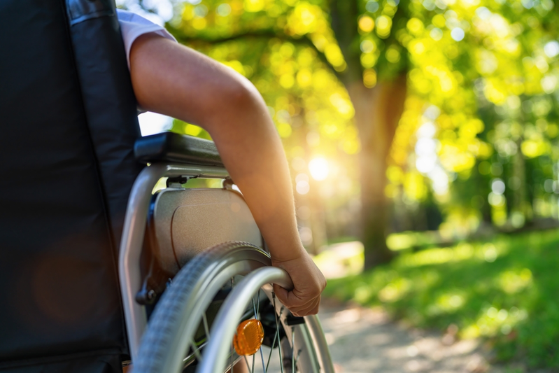 hand on wheelchair outdoors