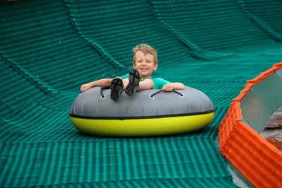 boy tubing down a hill