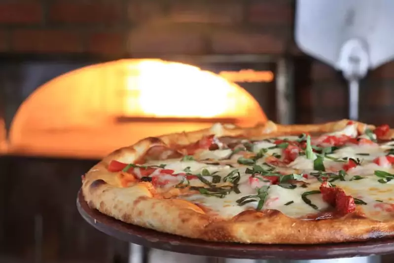 A wood fired pizza just taken from the oven