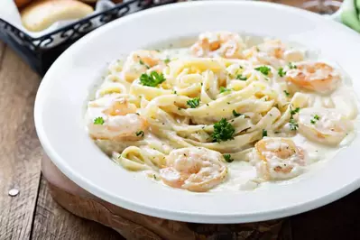 shrimp alfredo in white bowl