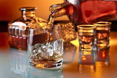 whiskey being poured in glass