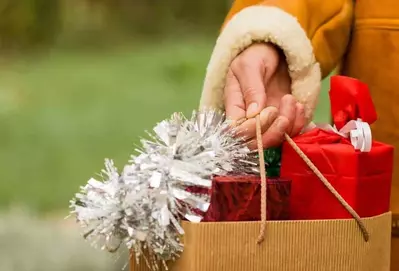 woman holding bags after christmas shopping