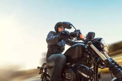 A man on a motorcycle with a blurred background.