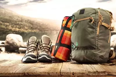 Hiking boots and hiking backpack on a deck