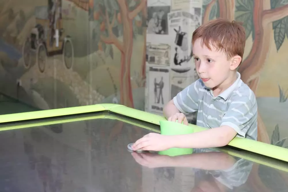 kid playing air hockey