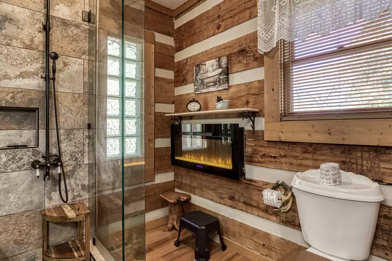 4 Paws Lodge master bathroom with year round electric fireplace