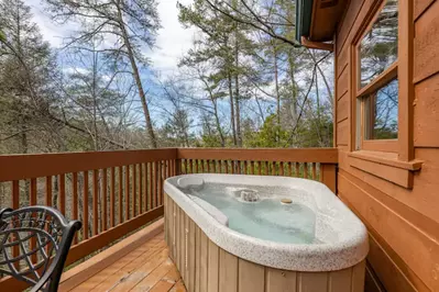 Relax in the 2-Person Hot Tub and Take in the Wooded Views