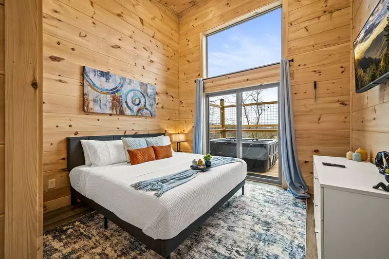 Step into luxury as our second bedroom opens onto a private deck featuring a soothing hot tub