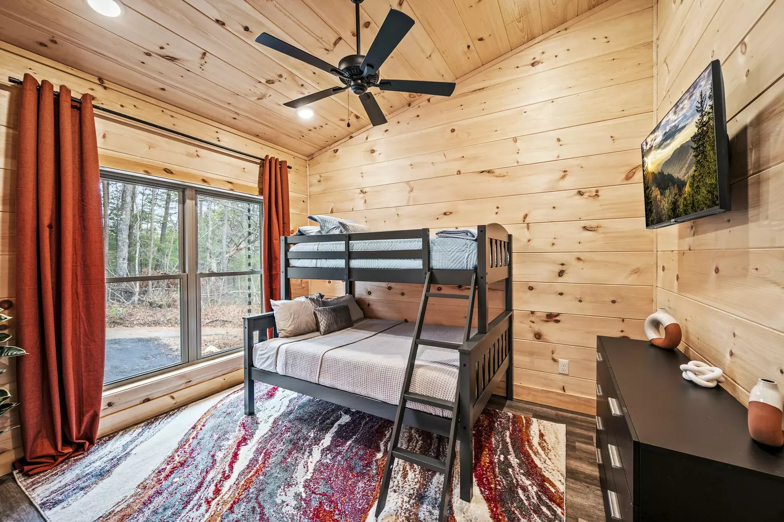 Unwind in our bunk bed haven with personal TVs for the perfect blend of comfort and entertainment