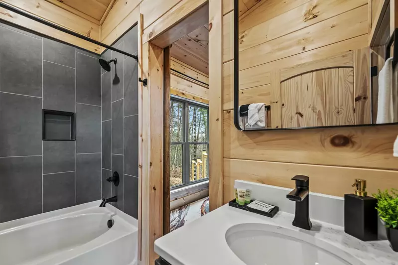 Indulge in luxury and unwind in the  common bathroom, featuring an elegant oval tub