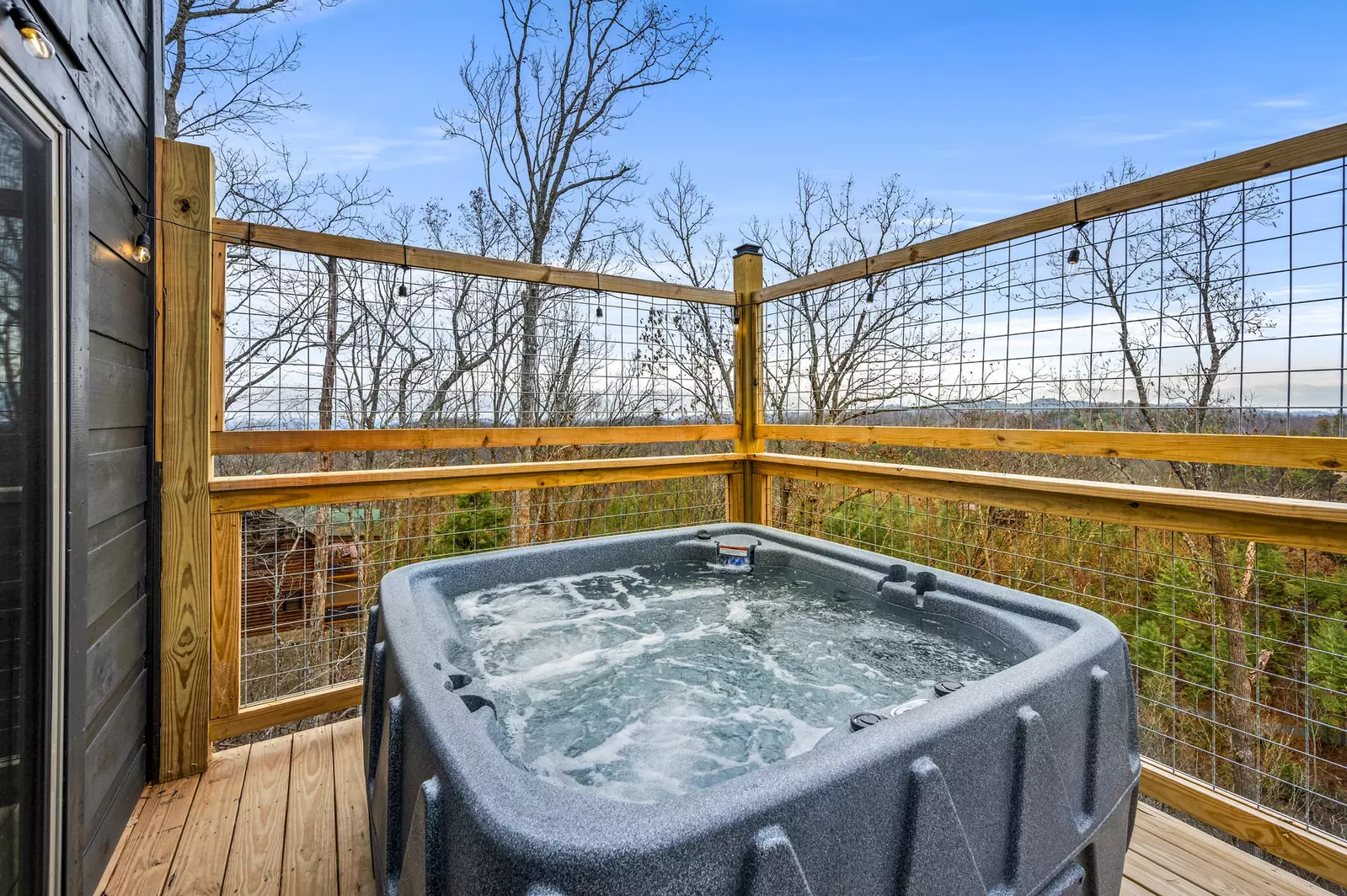 Indulge in luxury  where a  hot tub awaits with a panoramic view