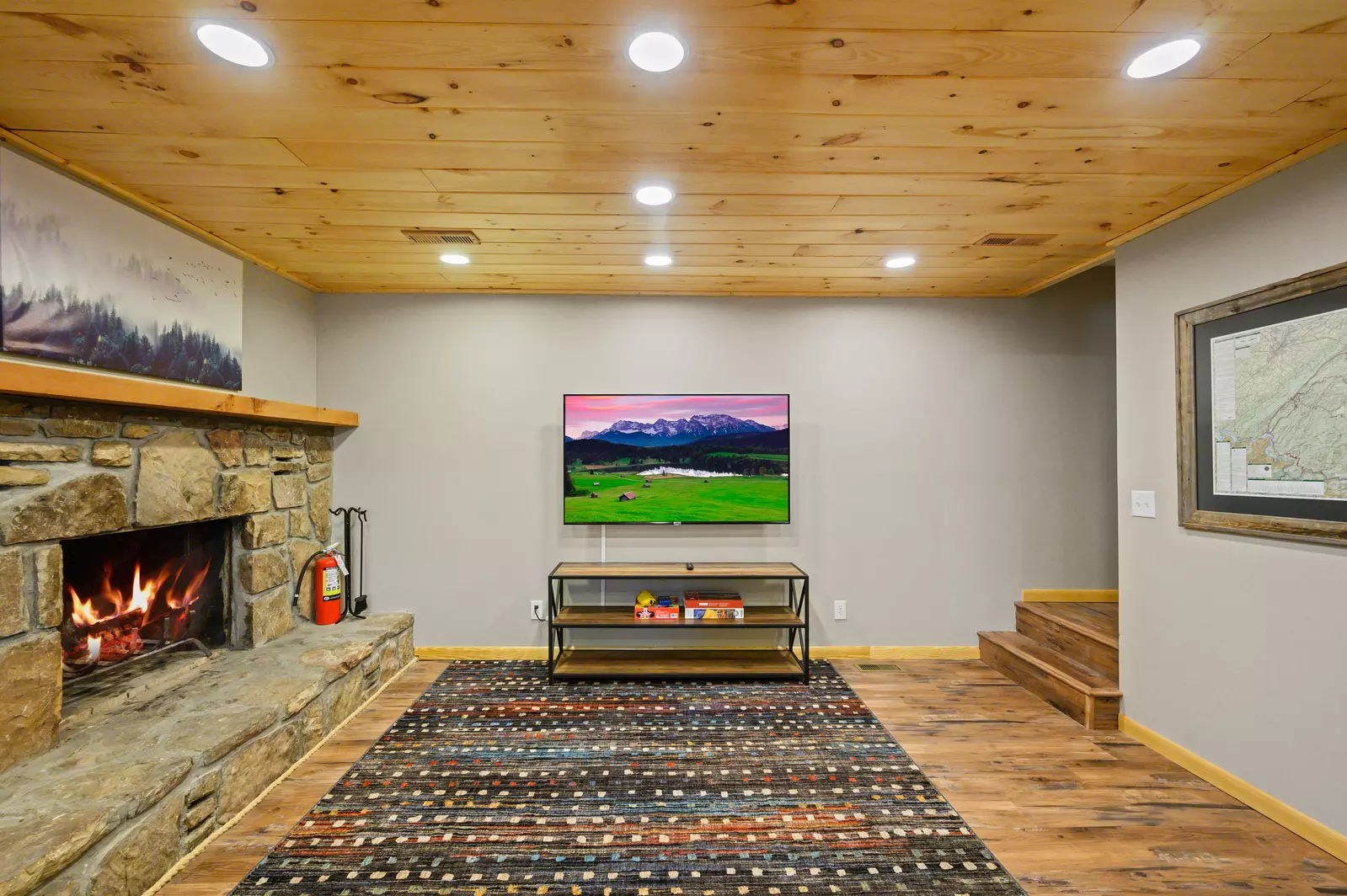 Lower level entertainment room with 65 inch Roku TV and wood burning fireplace!