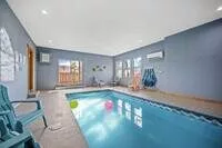 The heated indoor pool is located on the lower level of the cabin. A code to the lock on the door will be provided. The sliding door opens to the lower deck and hot tub outside.