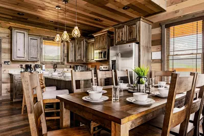 Our 8-persons dining table with our kitchen beyond.
