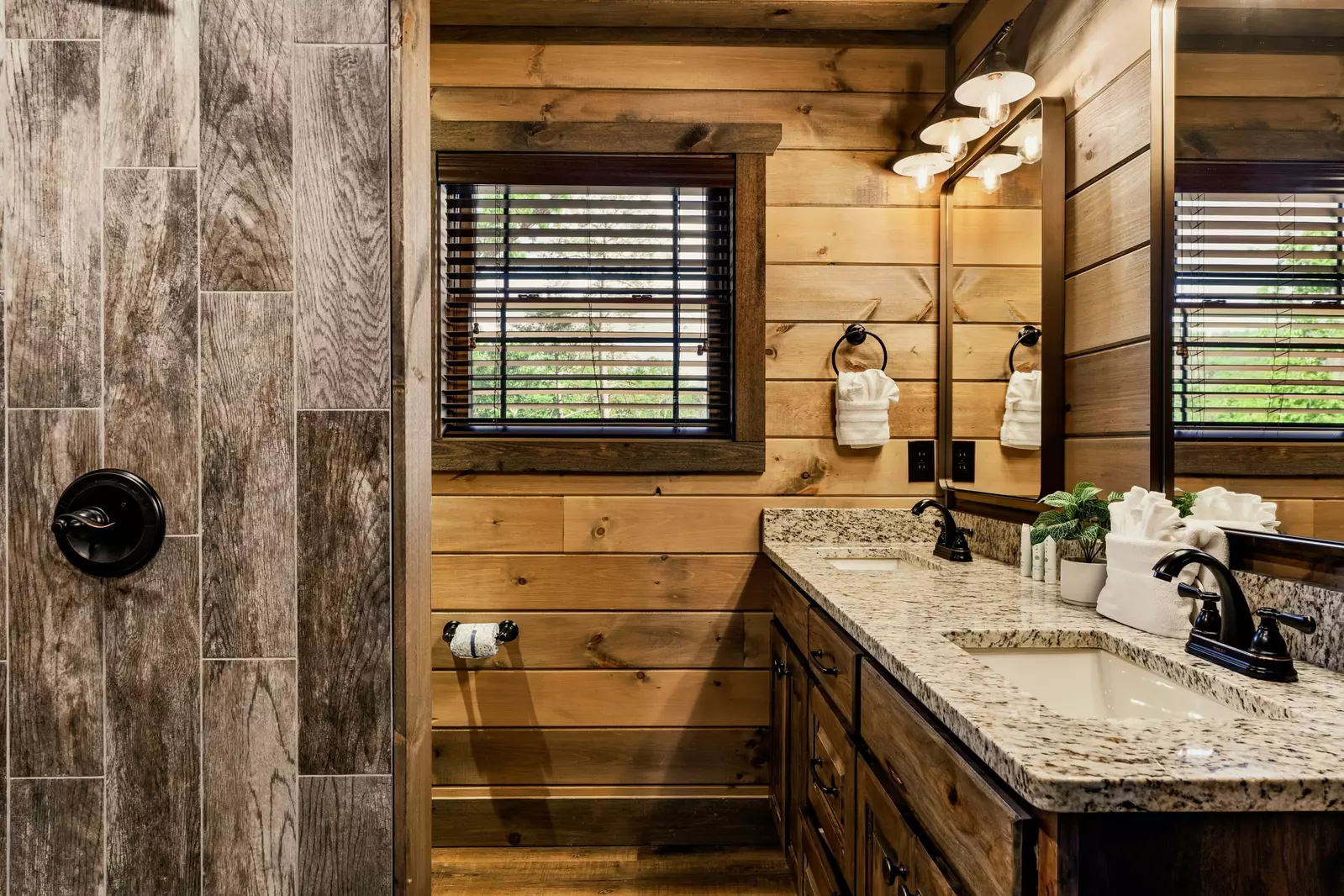 The bathroom of the upper level King bedroom. Double sinks and a stand-up shower