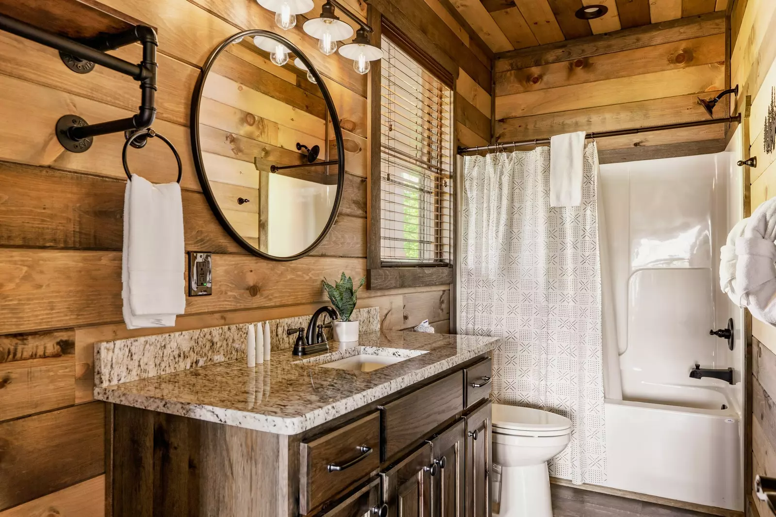 Main level bedroom bathroom with a bath tub/shower combo.