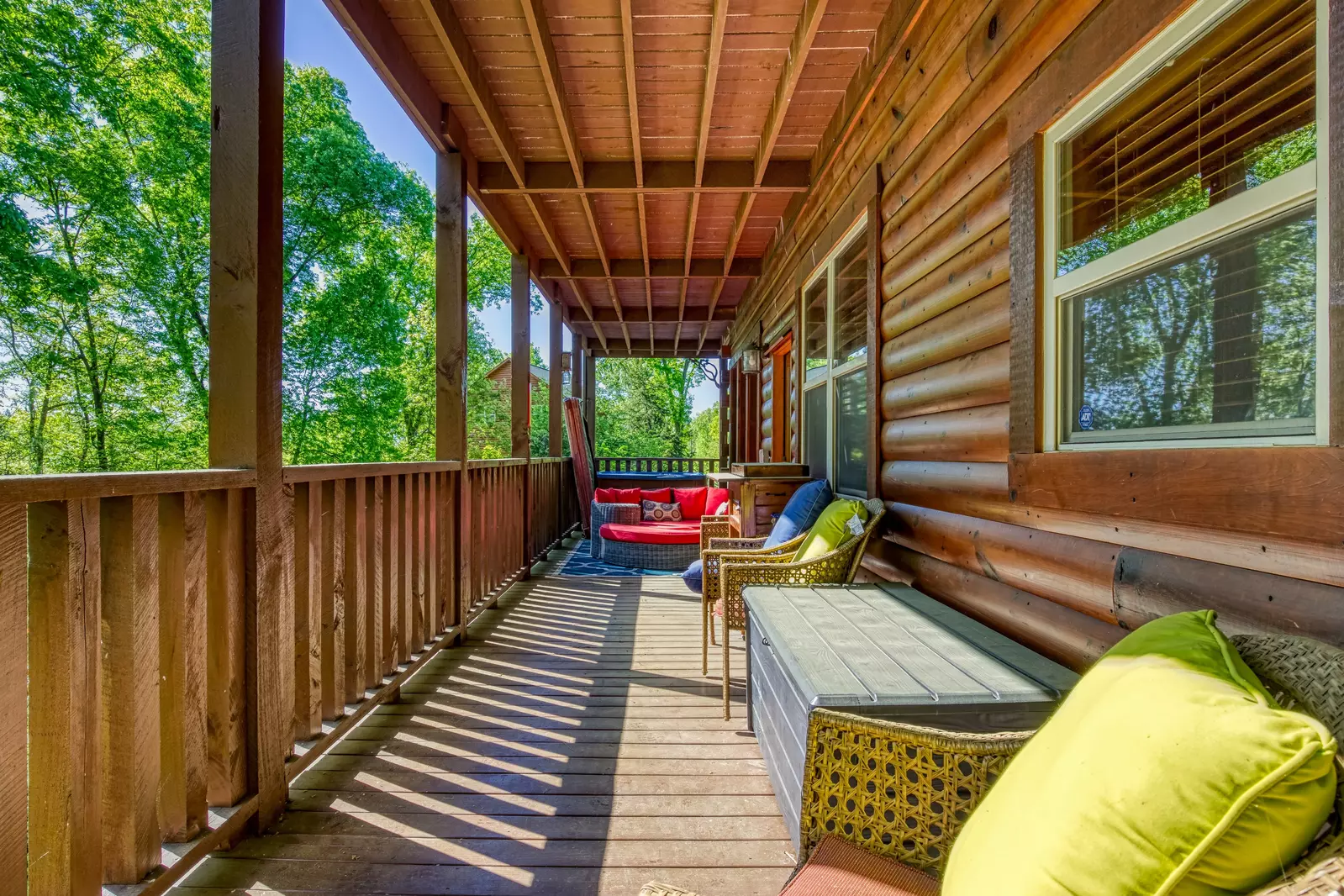 Antler Run main level covered wrap around deck with wicker outdoor furniture