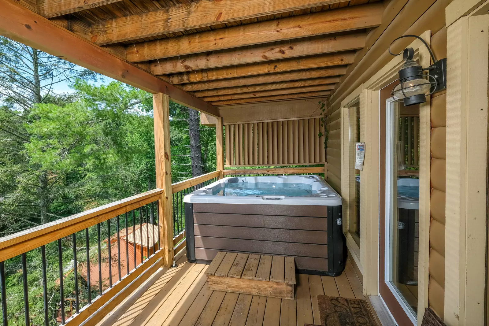 Bearadise Mountain Lodge back deck with a hot tub