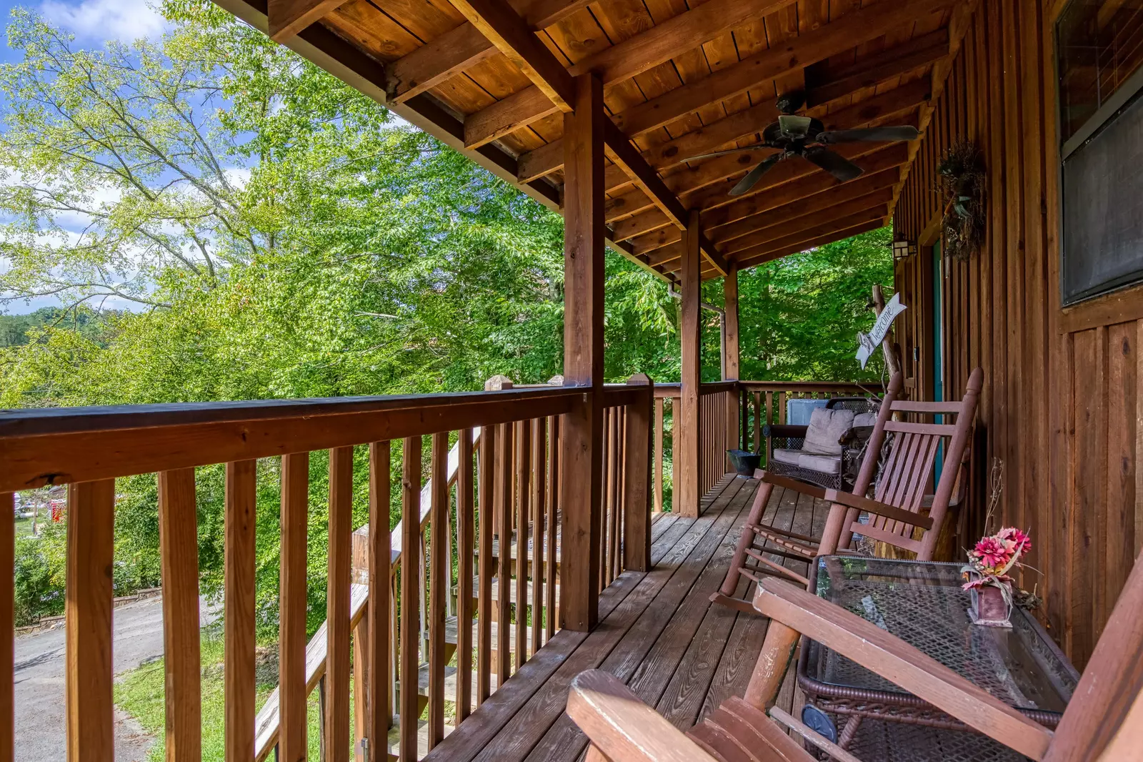 Country Charm covered entry deck with rocking chairs