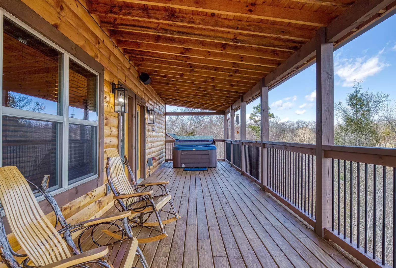 Cozy Cub Cabin upper level deck with rocking chairs