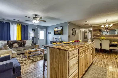 Four Bearoom Cottage kitchen island, living room, and dining area