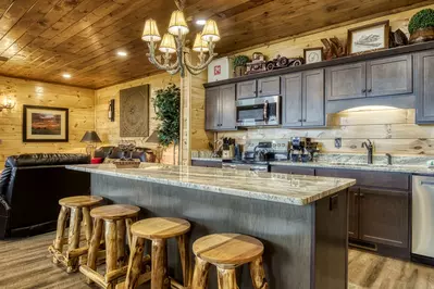 Mountown Moments Vista kitchen island, fully furnished kitchen, and living room