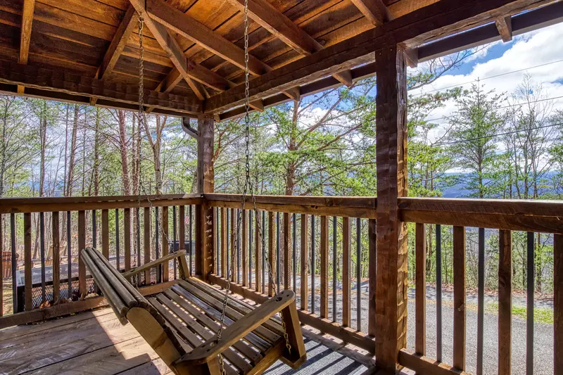 Old Glory covered front deck with swing