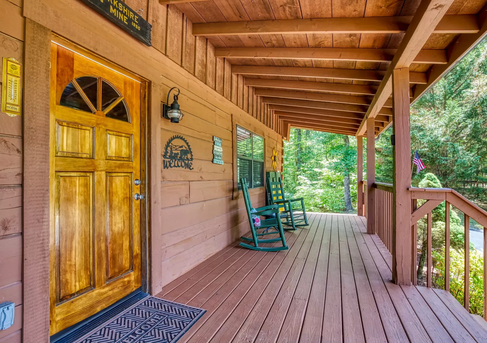 Serenity Ridge - Covered entry deck with rocking chairs