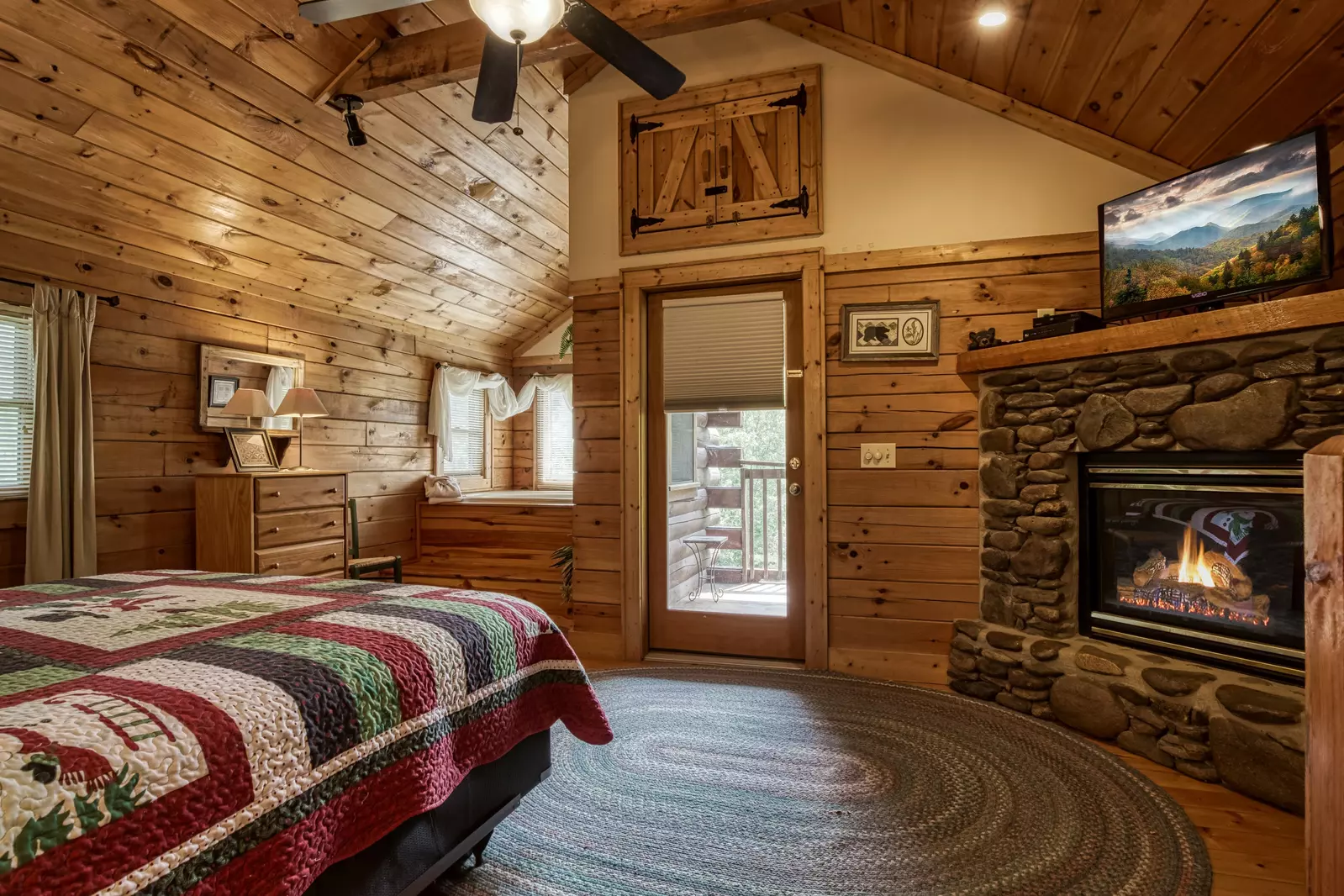 Tennessee Twilight Cabin upper level bedroom with stone encased gas fireplace