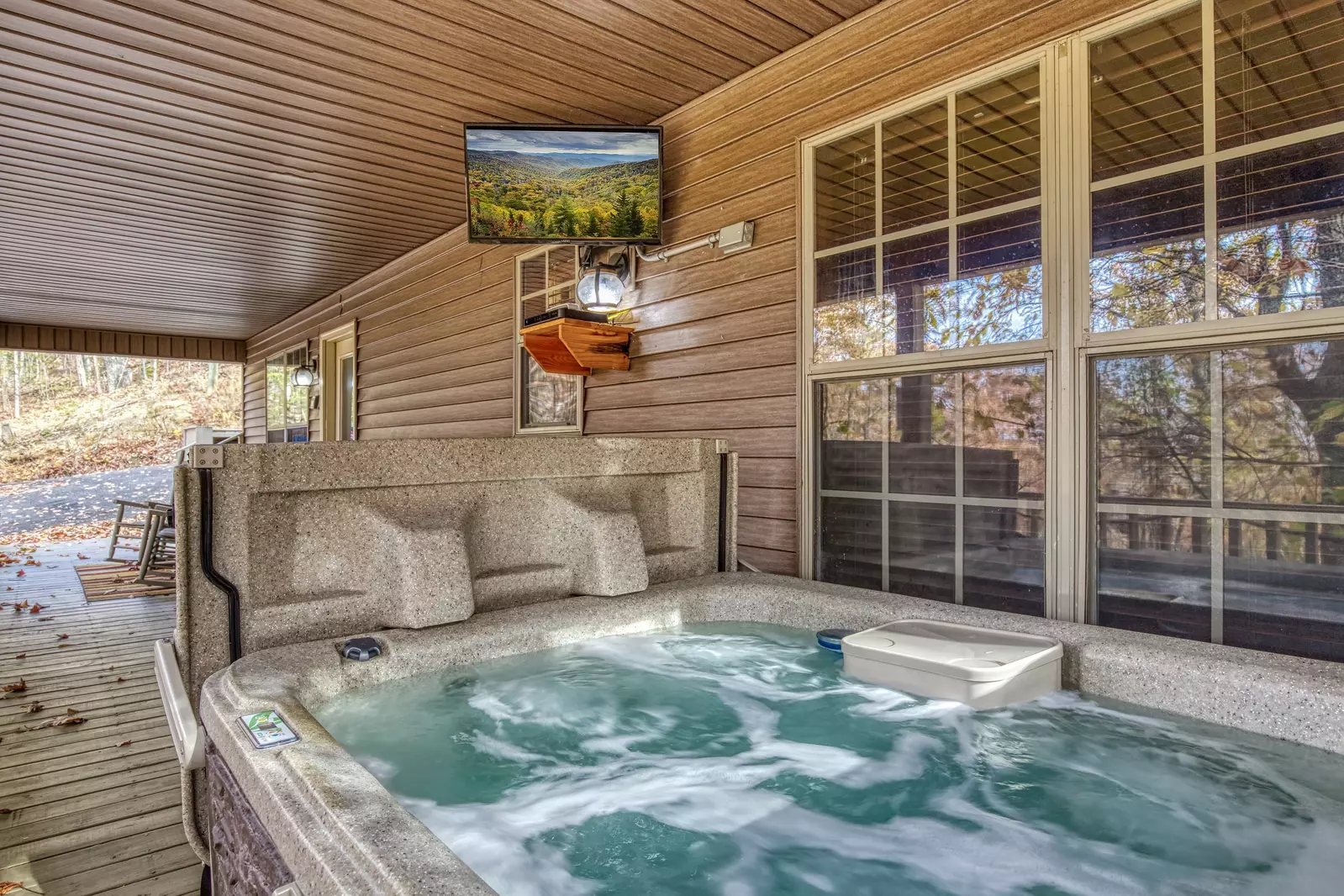 The Road Less Traveled covered back deck with hot tub and TV