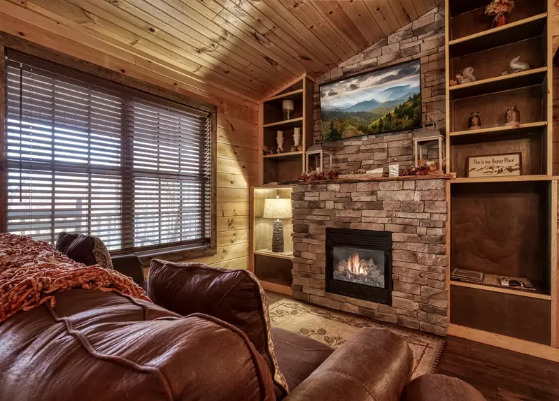 The Road Less Traveled living room with stone encased gas fireplace