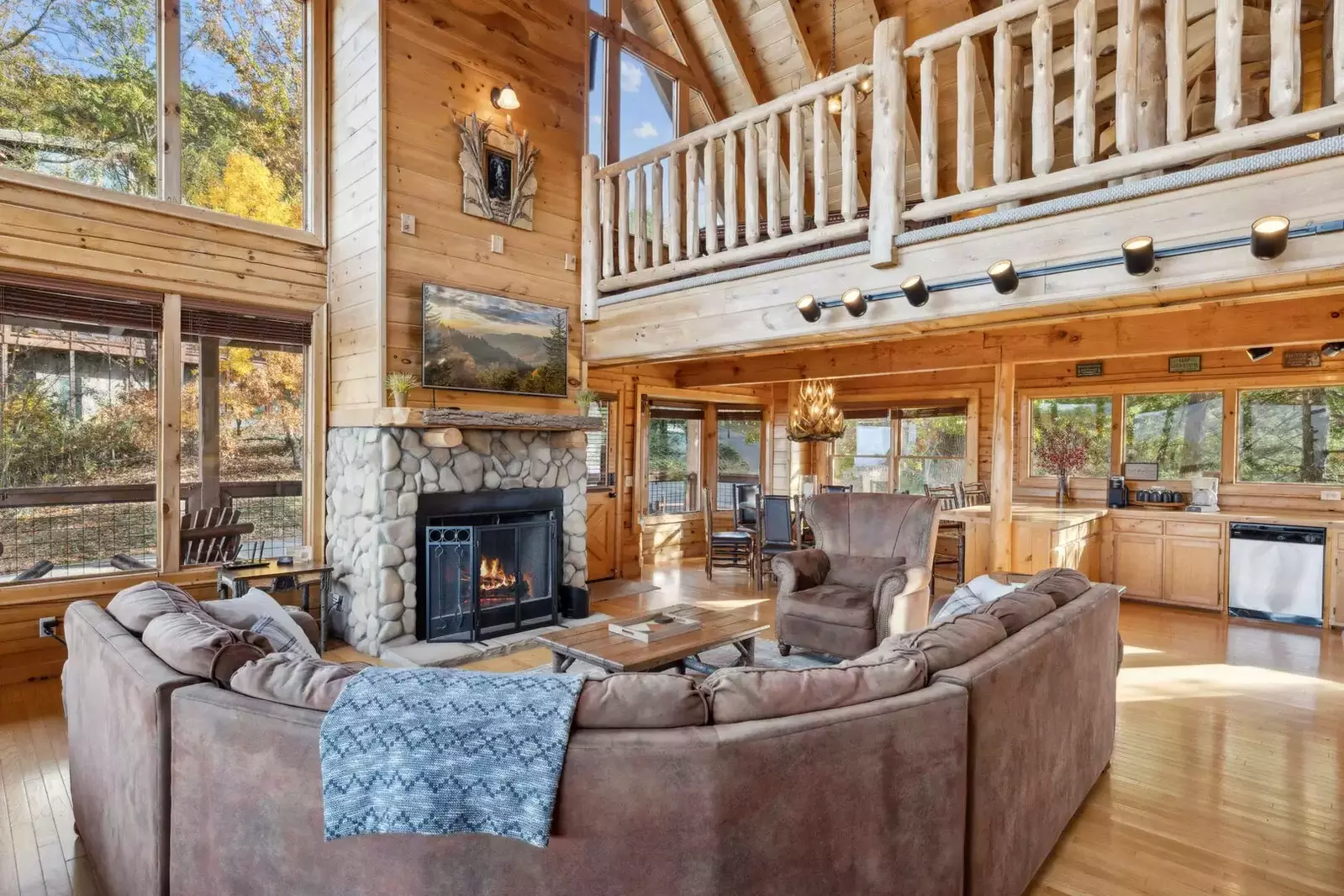 Vaulted ceilings in the living room open to the loft above and bring in two stories of light and views