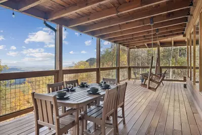 Enjoy a hot tub, outdoor dining, porch swing, or fire pit on the covered deck