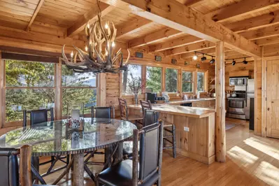 The kitchen and dining areas provide everything you need with a table seating 6, bar seating 2, and a fully stocked kitchen