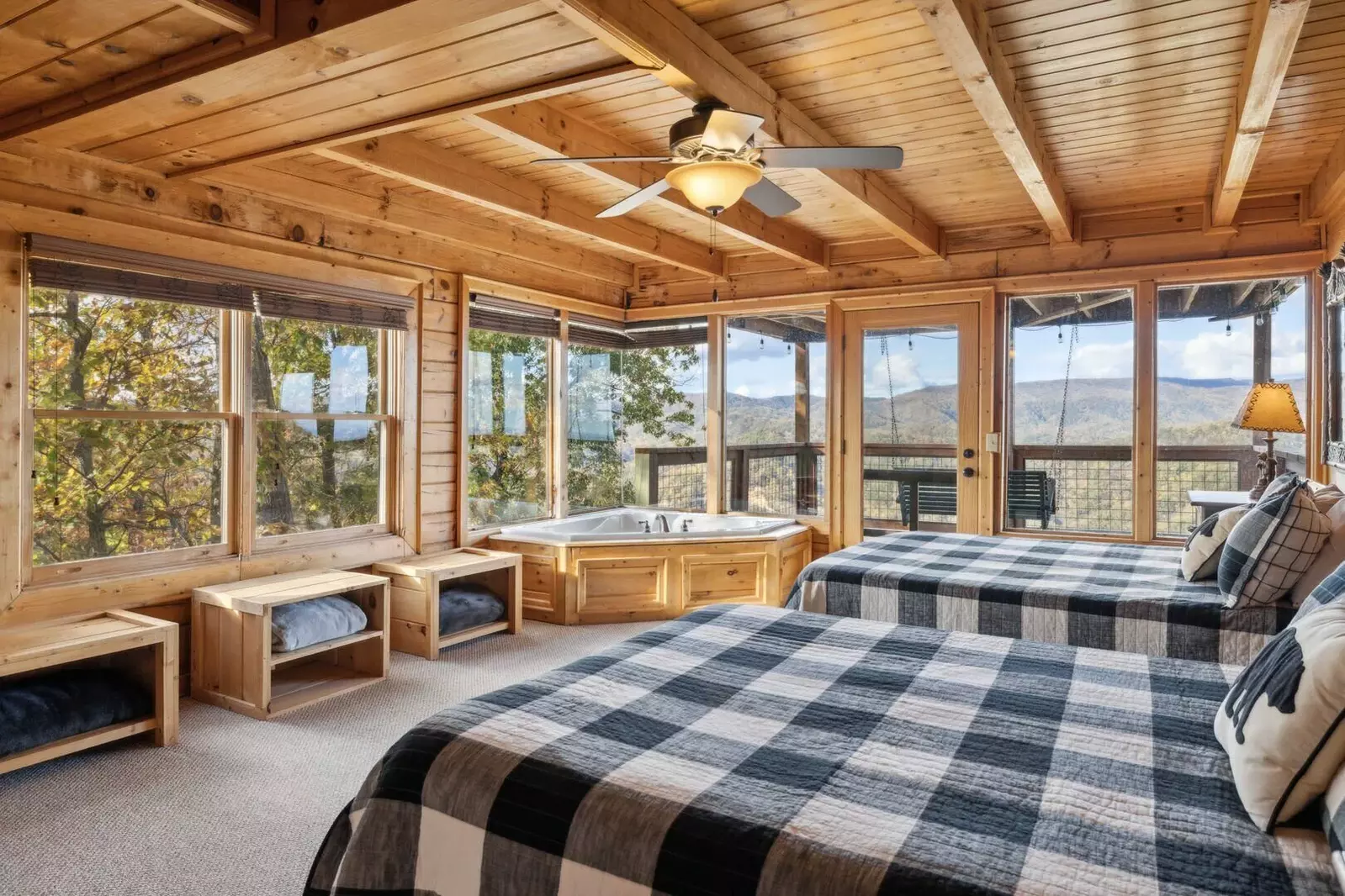 The 2nd-floor bedroom features 2 queen beds, jetted tub, private balcony, gas fireplace, TV, and ensuite bathroom