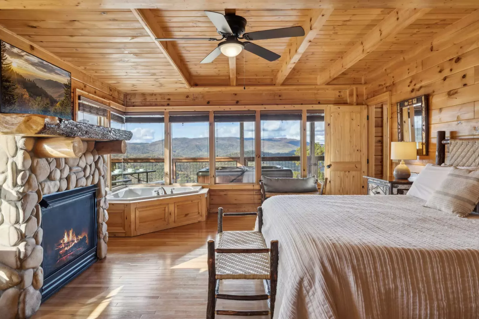 The 1st-floor bedroom features a king bed, jetted tub, gas fireplace, TV, desk, and ensuite bathroom