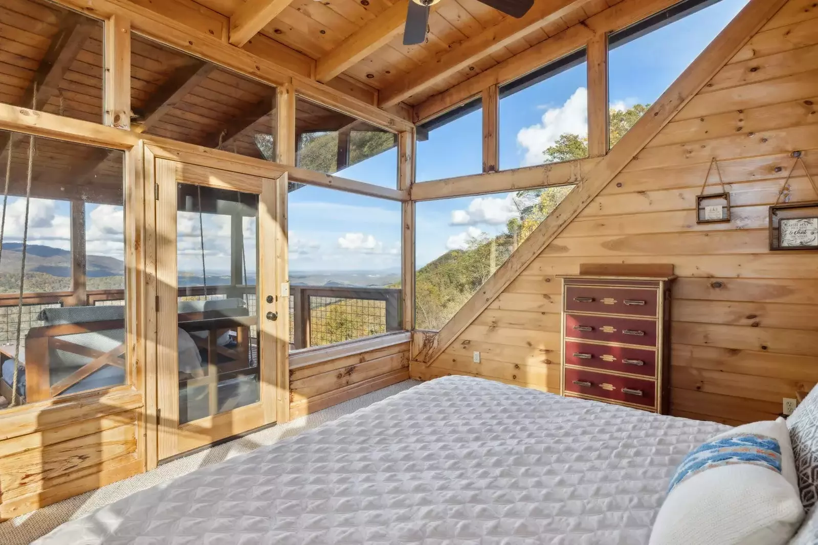 The 3rd-floor bedroom is a secluded "tree-top suite" that offers incredible views from its three walls of windows