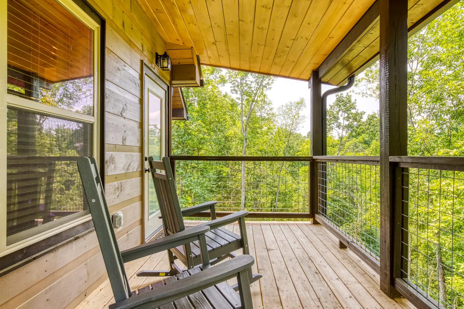 Mountain Memories main level covered back deck with rocking chairs