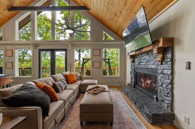 Living room with fireplace and woodsy views!