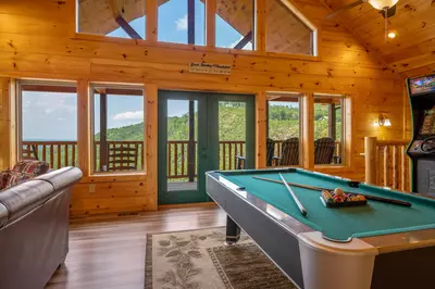 The game room offers breathtaking mountain views, arcade games, & 55" Roku TV