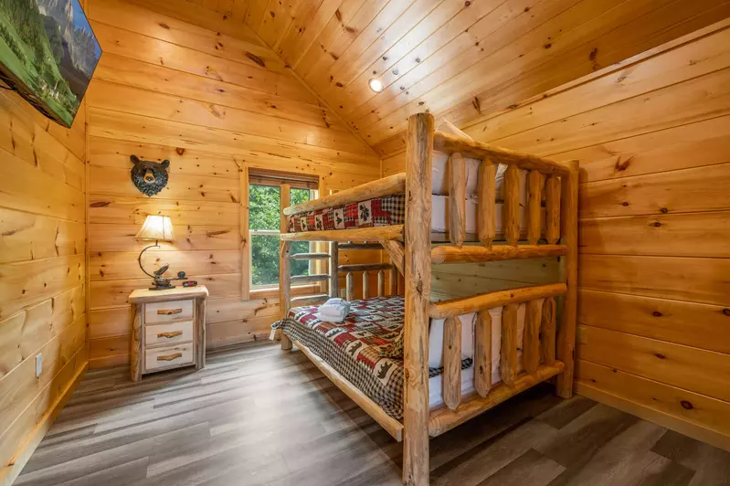 Upstairs bedroom with cabin-style queen bunk beds & attached bathroom
