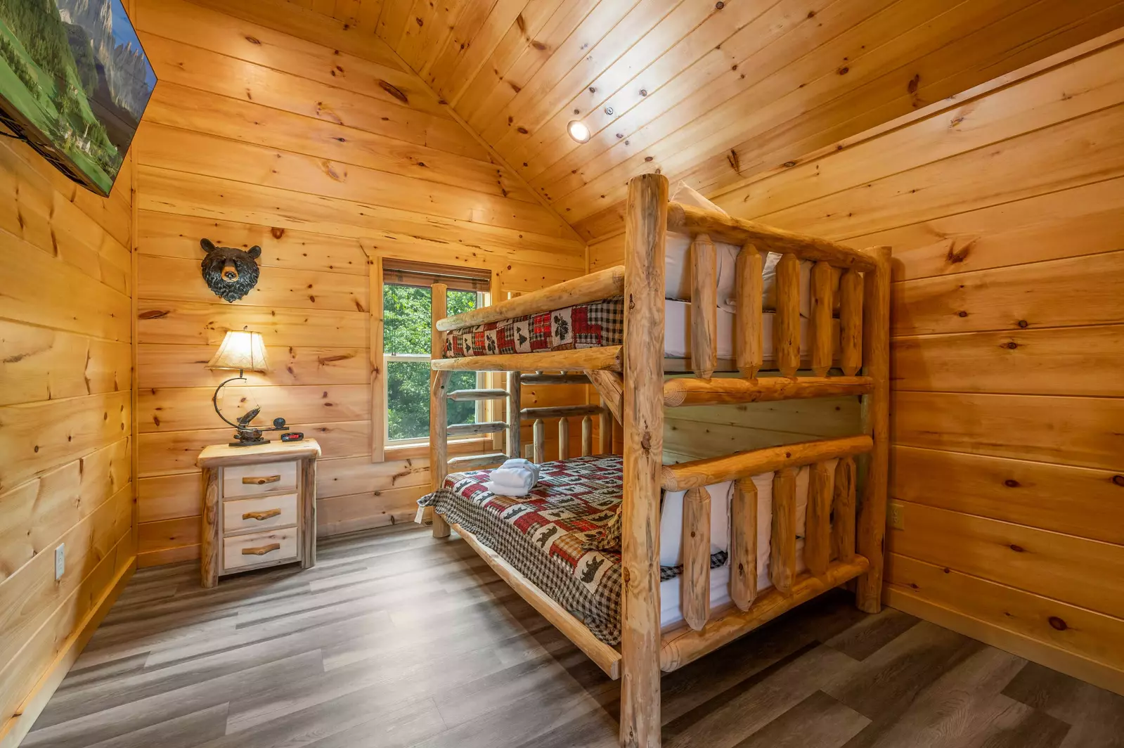 Upstairs bedroom with cabin-style queen bunk beds & attached bathroom